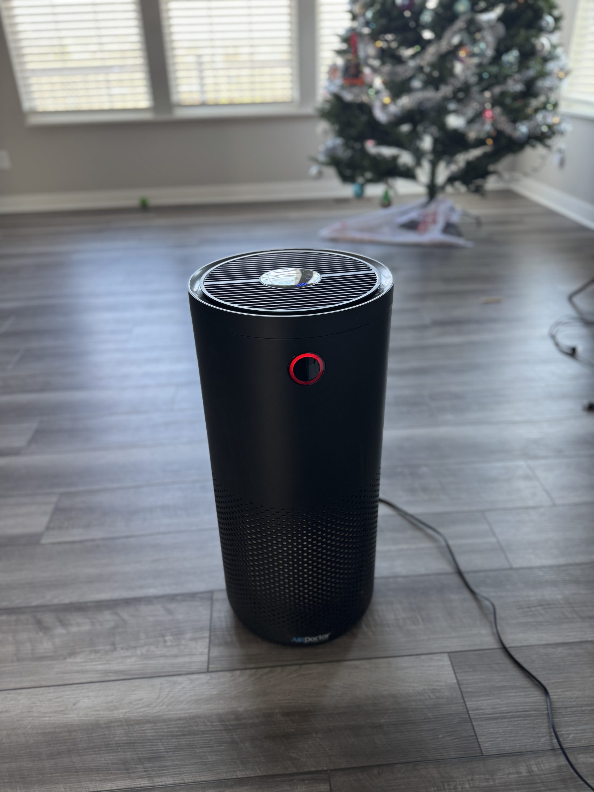 AirDoctor 4000 air purifier placed in my kitchen area showing the red air quality indicator light.