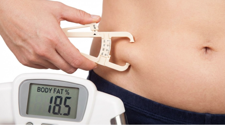 Body fat percentage measured with skinfold calipers, showing a more accurate way to assess body composition and fat levels beyond scale weight.