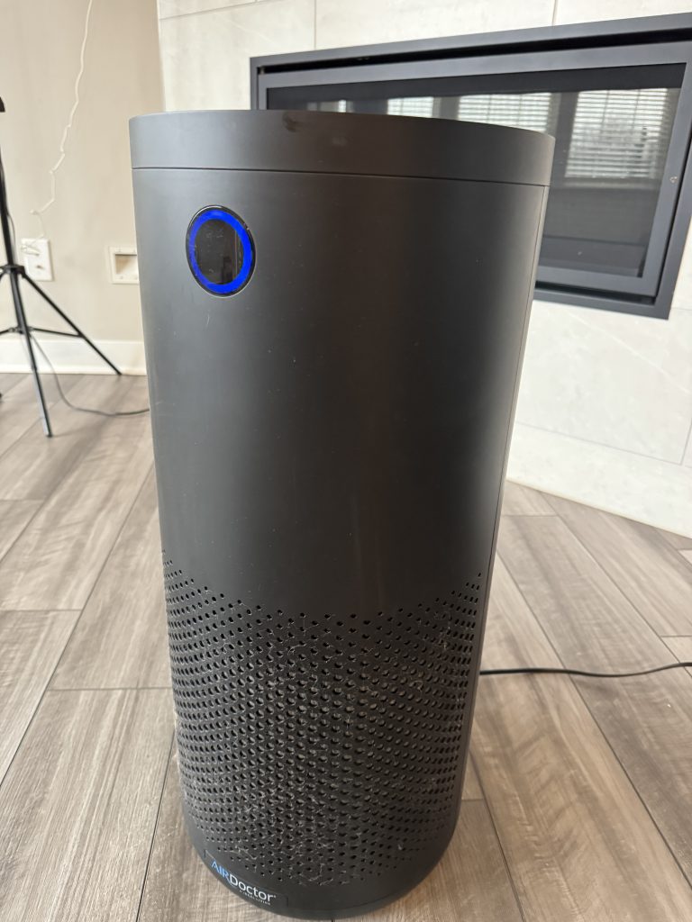 AirDoctor 4000 review front view showing air quality sensor ring in living room setting